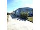 Light blue mobile home with landscaping and a driveway at 43 Castaway Ct, North Port, FL 34287