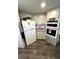 Well-equipped kitchen featuring white appliances, ample cabinetry, and practical countertops at 43 Castaway Ct, North Port, FL 34287