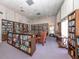 Community library with bookshelves, seating, and ample natural light at 43 Castaway Ct, North Port, FL 34287