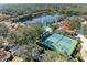 Aerial view of community with lake, pool, and tennis courts at 4417 Park Lake N Ter, Bradenton, FL 34209