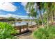 Wooden dock extending into a lake with lush greenery at 4417 Park Lake N Ter, Bradenton, FL 34209