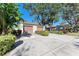 Two-car garage and a paved driveway, surrounded by greenery at 4417 Park Lake N Ter, Bradenton, FL 34209