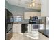 Modern kitchen with stainless steel appliances and white cabinets at 4417 Park Lake N Ter, Bradenton, FL 34209