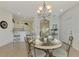 Dining area with glass-top table, decorative chandelier, and view of the kitchen at 4855 Whispering Oaks Dr, North Port, FL 34287