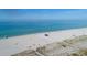 White sandy beach with turquoise waters, beachgoers, and volleyball net at 504 Narvaezi St # 119, Venice, FL 34285