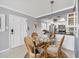 Dining area with wicker chairs and a glass table, adjacent to the kitchen at 504 Narvaezi St # 119, Venice, FL 34285