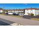 Apartment building exterior with a paved driveway and parked cars at 504 Narvaezi St # 119, Venice, FL 34285