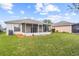 House featuring a screened porch and lush lawn at 5198 Layton Dr, Venice, FL 34293