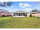 House with a screened porch and grassy backyard at 5198 Layton Dr, Venice, FL 34293