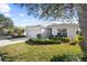 House exterior featuring a two-car garage and well-manicured lawn at 5198 Layton Dr, Venice, FL 34293