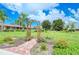 Landscaped garden area with brick path and arbor at 5198 Layton Dr, Venice, FL 34293