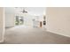 Spacious living room with carpet flooring and view to kitchen at 5198 Layton Dr, Venice, FL 34293