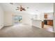 Open concept living room with kitchen and access to backyard at 5198 Layton Dr, Venice, FL 34293
