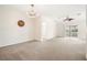 Bright living room featuring a ceiling fan and access to patio at 5198 Layton Dr, Venice, FL 34293
