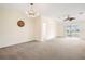 Living room with chandelier, ceiling fan and access to patio at 5198 Layton Dr, Venice, FL 34293