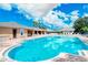 Community pool and clubhouse with lounge chairs at 5198 Layton Dr, Venice, FL 34293