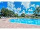 Community pool with lounge chairs and brick deck at 5198 Layton Dr, Venice, FL 34293