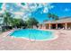 Community pool with lounge chairs and brick patio at 5198 Layton Dr, Venice, FL 34293