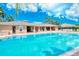 Community pool and clubhouse with lounge chairs at 5198 Layton Dr, Venice, FL 34293