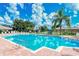 Community pool with lounge chairs and palm trees at 5198 Layton Dr, Venice, FL 34293