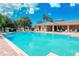 Community pool with lounge chairs and clubhouse at 5198 Layton Dr, Venice, FL 34293
