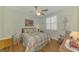 Bedroom with ceiling fan, wooden rocking chair, and floral-patterned bedspread at 5372 Oakmont Ct, North Port, FL 34287