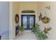 Elegant foyer with decorative double doors, potted plants, and wall art at 5372 Oakmont Ct, North Port, FL 34287