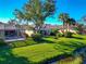 Attractive single-story home with a screened lanai, lush lawn, and waterfront access at 5856 Helicon Pl, Sarasota, FL 34238