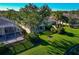 Elevated backyard view of homes with screened patios, green lawns, and landscaping at 5856 Helicon Pl, Sarasota, FL 34238