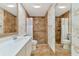 Spacious bathroom featuring tiled walls, white vanity, and accessibility features like grab bars at 5856 Helicon Pl, Sarasota, FL 34238