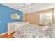Charming bedroom with blue accent wall, white furniture, and a ceiling fan at 5856 Helicon Pl, Sarasota, FL 34238