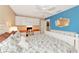 Cozy bedroom featuring a workspace, white furniture, and a blue accent wall at 5856 Helicon Pl, Sarasota, FL 34238