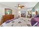 Inviting bedroom with wooden furniture, ceiling fan, and a glimpse of the ensuite bathroom at 5856 Helicon Pl, Sarasota, FL 34238