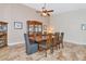 Elegant dining room with a large wooden table, grey chairs, and a china cabinet at 5856 Helicon Pl, Sarasota, FL 34238
