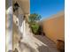 Side exterior view showcasing the walkway to the entrance and privacy wall at 5856 Helicon Pl, Sarasota, FL 34238