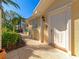 Welcoming front entryway with a white door, column accents, and lush landscaping at 5856 Helicon Pl, Sarasota, FL 34238