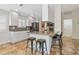 Modern kitchen with white cabinetry, dark countertops, and a breakfast bar at 5856 Helicon Pl, Sarasota, FL 34238