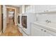 Laundry room with white cabinets, washer, dryer, and utility sink at 5856 Helicon Pl, Sarasota, FL 34238