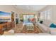 Living room with sliding glass doors to a patio, comfortable seating, and a ceiling fan at 5856 Helicon Pl, Sarasota, FL 34238