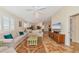 Inviting living room with comfortable seating, tile flooring, and access to the kitchen at 5856 Helicon Pl, Sarasota, FL 34238