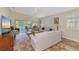 Open living room with tile floor, high ceilings, and a view of the patio and pond at 5856 Helicon Pl, Sarasota, FL 34238