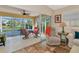 Enclosed patio with tile floor, sliding glass doors, and a view of the pond at 5856 Helicon Pl, Sarasota, FL 34238