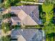 Aerial view of tile roofs, screened enclosures, and green spaces within a community at 5856 Helicon Pl, Sarasota, FL 34238