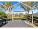 Spacious screened patio with a tranquil water view at 5856 Helicon Pl, Sarasota, FL 34238