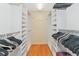 Large, organized walk-in closet with plenty of shelving and hanging space at 5856 Helicon Pl, Sarasota, FL 34238