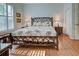 Cozy bedroom features a unique bedframe, wood floors and light blue walls at 589 Pond Willow Ln, Venice, FL 34292