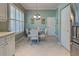 Cozy breakfast nook with a round table, comfortable chairs, and natural light from a window at 589 Pond Willow Ln, Venice, FL 34292