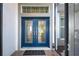 Elegant blue double front doors with decorative glass accents, a transom window, and a welcoming entrance at 589 Pond Willow Ln, Venice, FL 34292