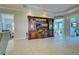 Spacious living room with tile flooring, built-in entertainment center, and views of other living areas at 589 Pond Willow Ln, Venice, FL 34292