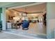 Open-concept living space with kitchen, living room, and dining area, showcasing seamless indoor-outdoor living at 589 Pond Willow Ln, Venice, FL 34292